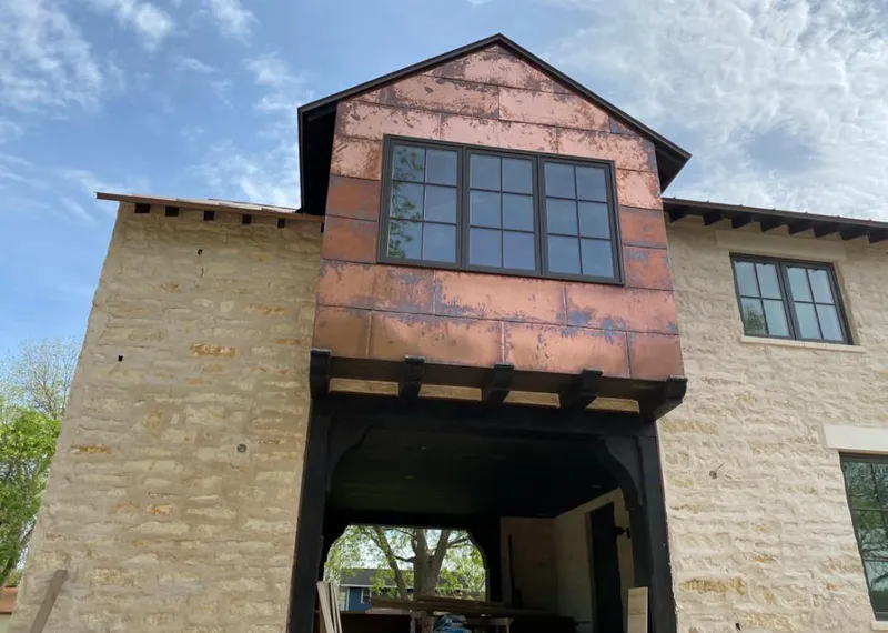 Copper metal panel facade on a stone building for Metal Roof Coating in Mexico